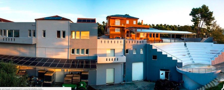 one side of the building with the outdoor stone amphitheater of Ktima Brintziki winery